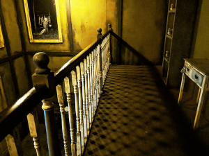 In-game: A view atop the balcony, the railing is casting an intricate shadow.