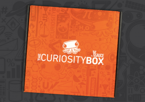 The orange Curiosity Box featuring an adorable octopus logo.