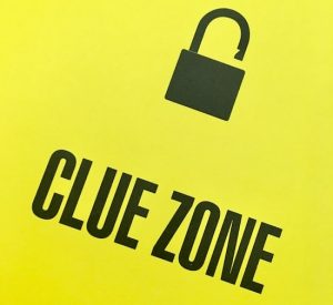 In-book, page reads, "Clue Zone" with an unlocked padlock.