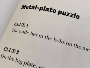 In-book, page,shows portions of the first puzzle's hints.