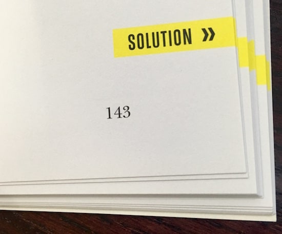 In-book, page shows that the puzzle's solution is on the next page.