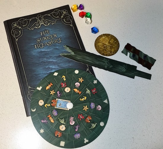 The sunken treasure journal, decoder wheel, and an assortment of small components.