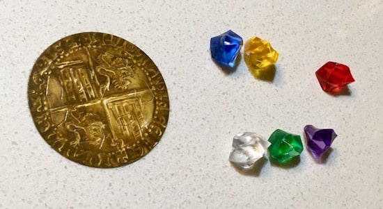 An old gold coin and 6 gems of different colors.