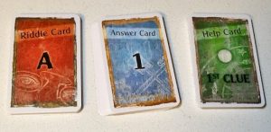 Stacks of riddle, answer, and help cards.