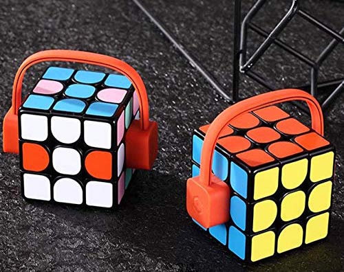2 Rubik's cubs with funny looking headset power chargers on them.