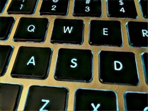Close up of glowing WASD keys on an keyboard.