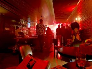 In-game: A busy bar lit red.