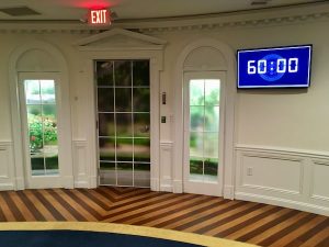 In-game: A 60 minute timer screen beside the windows and doors of the Oval Office.