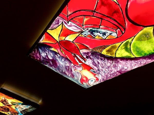 In-game: a stain-glass window depicting a fire-breathing dragon.