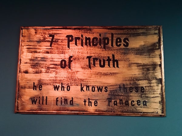 In-game: sign reads, "7 principles of truth: he who knows these will find the Panacea."
