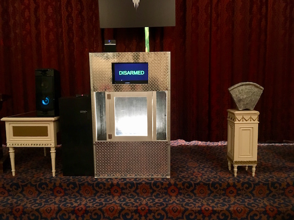 In-game: Close-up of a large metal device that displays the word, "Disarmed" beside a mystical artifact.