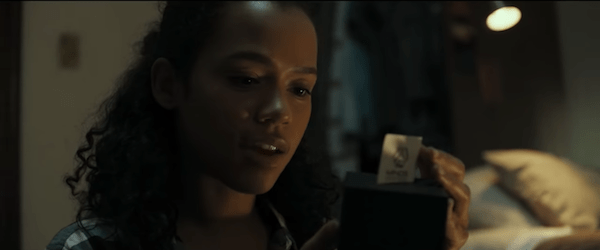 A character solving a puzzle box.