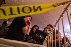 In-experience: 4 players looking at a computer with intense facial expressions.