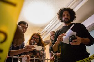 In-experience: 4 players looking over something with intense facial expressions.