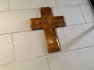 In-game: A cross hanging on a concrete wall.