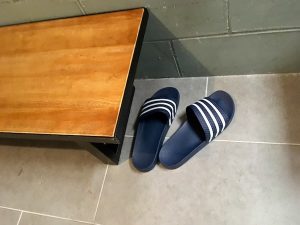 In-game: flip flops on the floor beside a bench.
