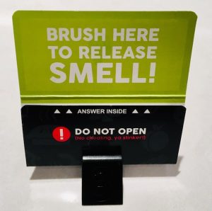 A smell card with instructions where to scratch.