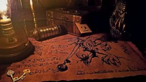 In-game: a cryptex an unrolled scroll, a locked box and an idol.