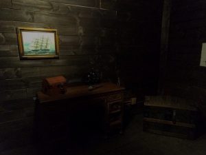 In-game: The captain's desk and a locked chest aboard a pirate ship.