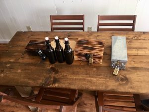 In-game: A tabletop mini puzzle game featuring 4 locked boxes and 3 bottles.