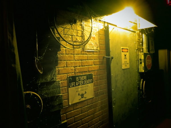 In-game: a brick wall with electrical boxes and pipes.