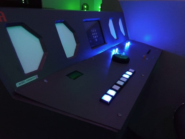 In-game: A space ship control panel with glowing buttons.