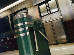 In-game: An authentic turn style before a subway car.