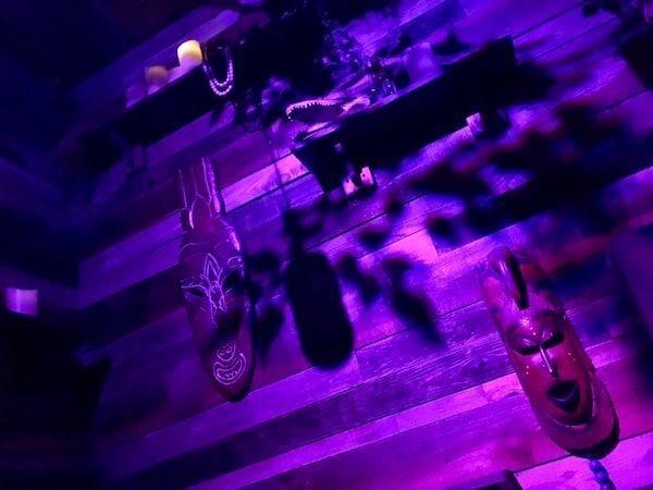 In-game: A wall of wooden masks and totems.