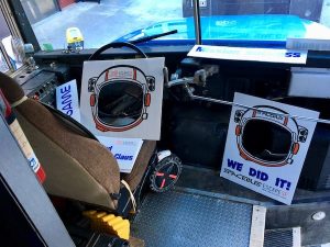 In-game: The front of the Space Bus filled with post-game signs.