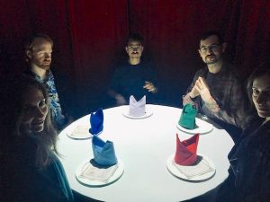 In-game: Team B surrounding their white table.