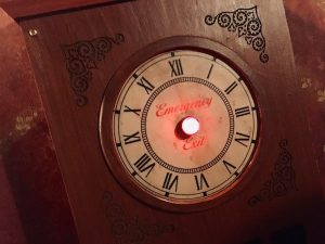 In-game: Closeup of a glowing red Emergency Exit button.