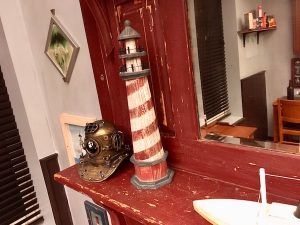 In-game: statues of a lighthouse and a hard-helmet for diving.