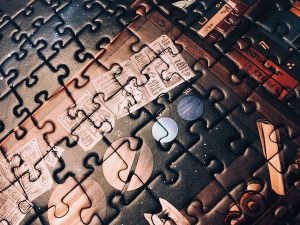 Portion of an assembled jigsaw puzzle featuring a map of the planets.