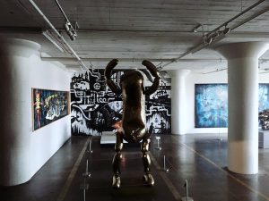 A strange pickle like sculpture in an art gallery.