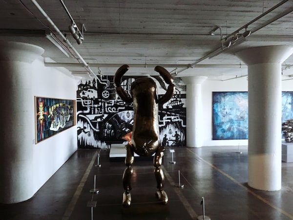 A strange pickle like sculpture in an art gallery.