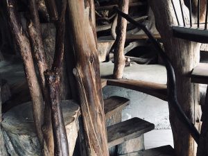 A wooden spiral staircase made from whole trees.
