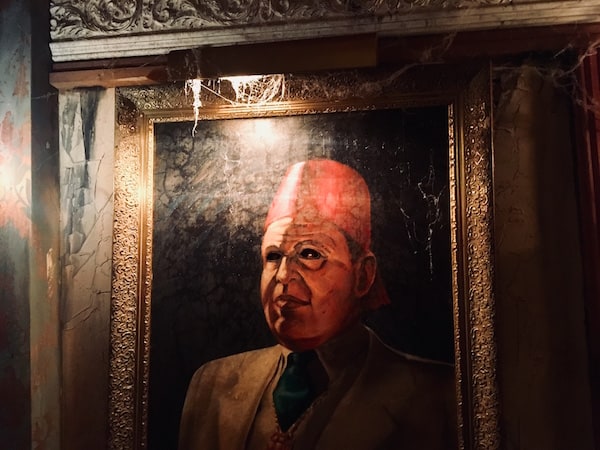 In-game: a creepy portrait with its eyes cut out.