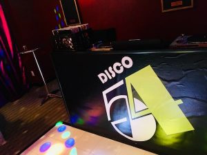 In-game: the DJ booth labeled "Disco 54."