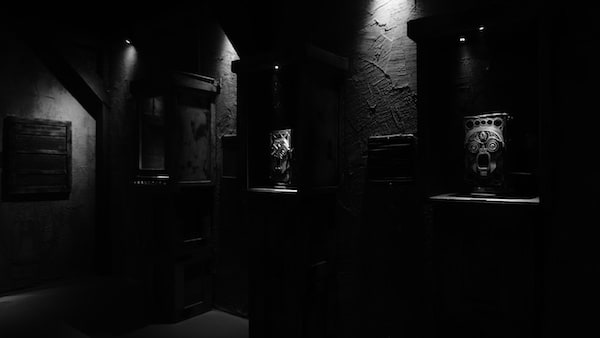 In-game: a shrine with mask carvings.