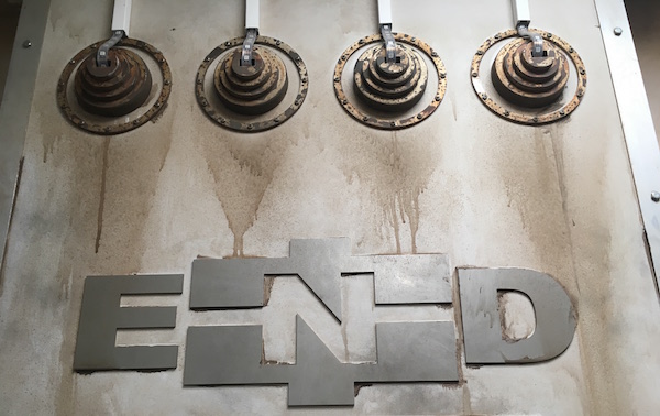 In-game: a rundown scifi-esque wall-mounted logo that reads "END"