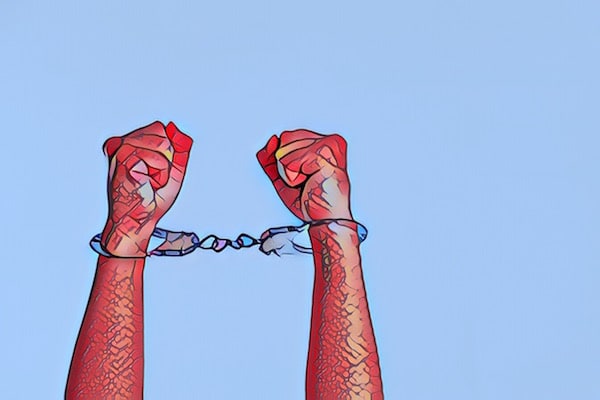 Stylized image of hands raised with handcuffs binding them together.