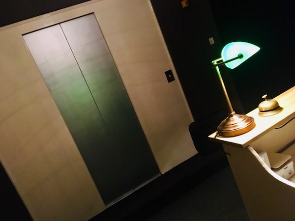 In-game: An elevator door viewed from the front desk.