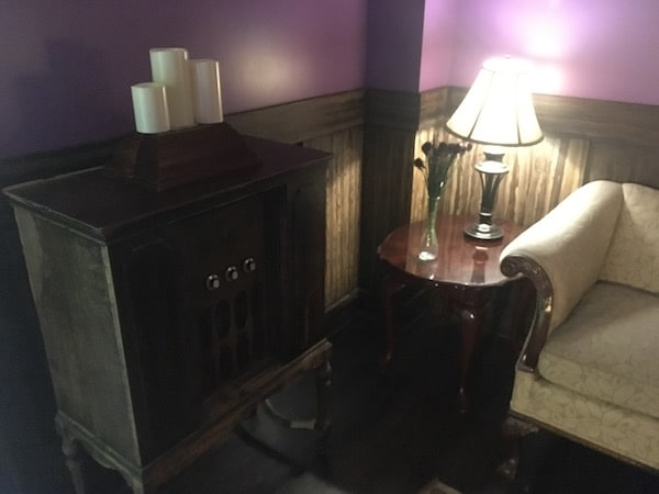 In-game: A large antique radio beside a couch.