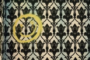 A smiley face spray painted and shot into the wall of 221B Baker Street.