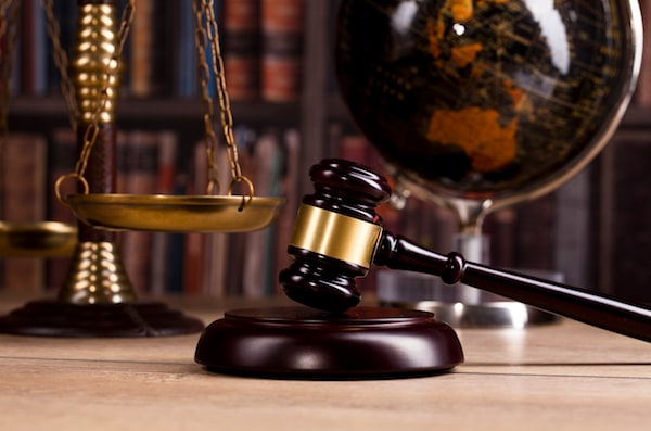 In-game: A gavel beside the scale of justice.