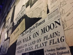 In-game: A wall of newspaper clippings, the NY Times piece about Apollo 11 in focus.