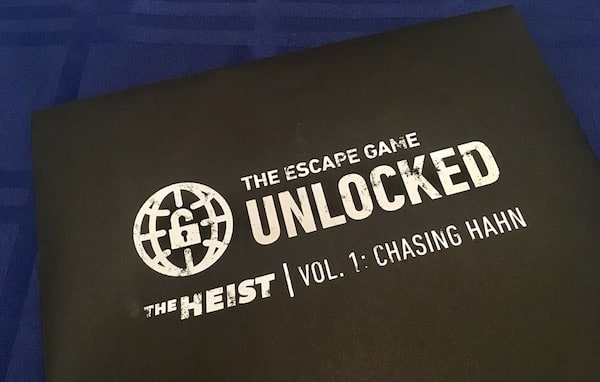 The sealed black envelope for The Escape Game Unlocked, The Heist Vol 1: Chasing Hahn.