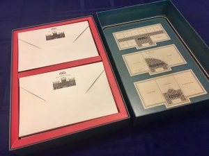 The opened box reveals stacks of invitations and a map of the hotel.