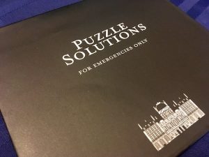 An envelope labeled "Puzzle Solutions for emergencies only"