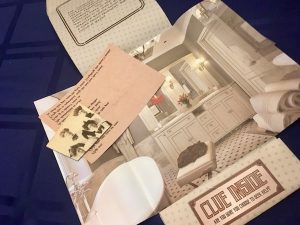 Our room opened up, reveals an image of a luxurious white bathroom. There is a note and a portion of a photo.